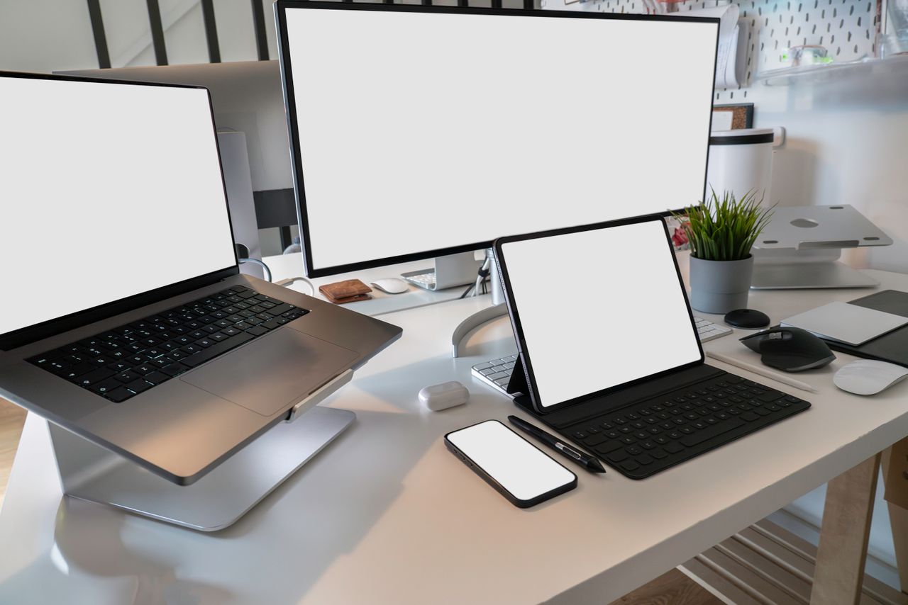 hero-img-02 A clean and modern workspace featuring a laptop, tablet, smartphone, and monitor. Ideal for remote work and tech setups.